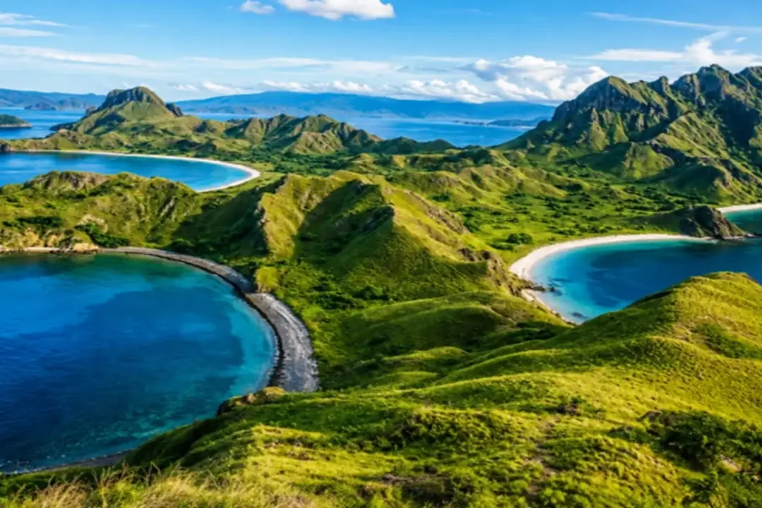 Padar Island viewpoint overlooking three turquoise bays and dramatic green hills in Komodo National Park, Indonesia